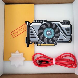 Griftmeter GPU shell in its shipping box with the dial lit and reading Codex usage, beside the envelope, stand and red cable