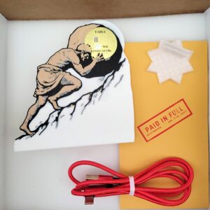 Griftmeter Sisyphus shell in its shipping box with the dial lit and showing a live reading, beside the envelope, stand and red cable